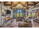 Spacious living room featuring a stone fireplace, vaulted wood ceilings, and panoramic mountain views at 242 Point View Pl, Breckenridge, CO 80424