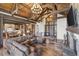 Open-concept with a stone fireplace, wood beams, and large sectional sofa at 242 Point View Pl, Breckenridge, CO 80424