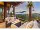 Covered outdoor patio featuring cozy seating, a fire table, and picturesque forest landscape views at 242 Point View Pl, Breckenridge, CO 80424