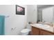 The bathroom has a light wood vanity, framed art, and soft lighting to create a spa-like feel at 22044 E Jamison Pl, Aurora, CO 80016