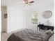 This bedroom features neutral walls, a ceiling fan, and a sunny window with a small desk area at 22044 E Jamison Pl, Aurora, CO 80016