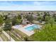 Aerial view of the neighborhood pool and playground area with lush trees and well-maintained landscaping at 22044 E Jamison Pl, Aurora, CO 80016