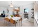 Open dining space with contemporary lighting and access to outdoor patio at 22044 E Jamison Pl, Aurora, CO 80016
