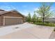 Home featuring a two-car garage, spacious driveway, and professional landscaping at 22044 E Jamison Pl, Aurora, CO 80016