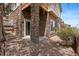 The exterior is stone with a sliding door to the walk out basement and a pebble ground cover at 22044 E Jamison Pl, Aurora, CO 80016