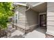 Inviting front porch with neutral siding and stone base offers a welcoming entry at 22044 E Jamison Pl, Aurora, CO 80016