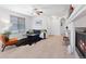 Cozy living room with a decorative fireplace, modern furnishings, and bright lighting at 22044 E Jamison Pl, Aurora, CO 80016