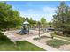 Community playground with slide, climbing structure and beautiful landscaping and sidewalk at 22044 E Jamison Pl, Aurora, CO 80016