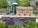 Neighborhood signage with lush landscaping and playground at 22044 E Jamison Pl, Aurora, CO 80016
