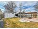 Backyard with patio, pergola, and detached garage at 1671 S Chase St, Lakewood, CO 80232