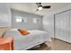 Cozy bedroom with hardwood floors, ceiling fan, and ample closet space at 1671 S Chase St, Lakewood, CO 80232