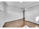 Spacious bedroom with hardwood floors and double doors to closet at 1671 S Chase St, Lakewood, CO 80232