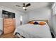 Bright bedroom with hardwood floors, ceiling fan, and a dresser at 1671 S Chase St, Lakewood, CO 80232