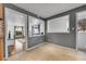 Bright hallway with gray walls and view into living room at 1671 S Chase St, Lakewood, CO 80232
