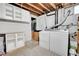 Basement laundry room with washer, dryer, and cabinets at 1671 S Chase St, Lakewood, CO 80232