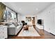 Bright living room featuring hardwood floors, a comfortable sofa, and plenty of natural light at 1671 S Chase St, Lakewood, CO 80232