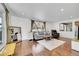 Comfortable living room with hardwood floors, ample seating, and a large window with backyard view at 1671 S Chase St, Lakewood, CO 80232