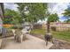 Lush backyard with outdoor dining area, grill, and bench seating at 3358 S Iris Ct, Lakewood, CO 80227