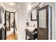 Stylish bathroom features a vessel sink, modern fixtures, and a shower-tub combination at 3358 S Iris Ct, Lakewood, CO 80227