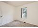 Bedroom featuring a window with tree views and neutral paint at 3358 S Iris Ct, Lakewood, CO 80227