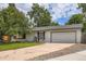 Charming single story home featuring an attached two car garage and mature landscaping at 3358 S Iris Ct, Lakewood, CO 80227