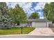 Charming single story home featuring an attached two car garage and lush lawn at 3358 S Iris Ct, Lakewood, CO 80227