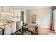 Bright kitchen featuring white cabinetry and tile backsplash at 3358 S Iris Ct, Lakewood, CO 80227