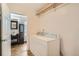 Bright laundry room with washer, dryer, and access to a stylish bathroom at 3358 S Iris Ct, Lakewood, CO 80227