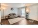 Cozy living room with wood floors, an area rug and a large window at 3358 S Iris Ct, Lakewood, CO 80227