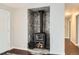 Living room showing wood burning stove with beautiful tile surround and dark wood floors at 3358 S Iris Ct, Lakewood, CO 80227