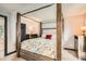 Main bedroom displaying a four-poster bed, neutral walls, carpet floors, and an abundance of natural light at 3358 S Iris Ct, Lakewood, CO 80227