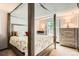 Bedroom featuring a four-poster bed, soft natural light, and complementing furniture sets at 3358 S Iris Ct, Lakewood, CO 80227