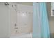 Bathroom with shower/tub combo, tile surround, and blue shower curtain at 770 Copper Ln # 206, Louisville, CO 80027