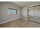 Bedroom with wood-look floors and mirrored closet doors at 770 Copper Ln # 206, Louisville, CO 80027