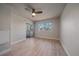 Bright bedroom with wood-look floors, ceiling fan, and access to balcony at 770 Copper Ln # 206, Louisville, CO 80027