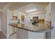 Modern kitchen featuring granite countertops and white cabinets at 770 Copper Ln # 206, Louisville, CO 80027