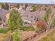 Aerial view of a home with deck and a lush landscaped backyard at 7138 Mountain Brush Cir, Highlands Ranch, CO 80130