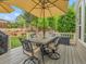 Outdoor dining area on wooden deck with table and chairs and green lush landscape at 7138 Mountain Brush Cir, Highlands Ranch, CO 80130