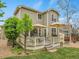 Inviting backyard deck with outdoor dining, a grill, and two umbrellas at 7138 Mountain Brush Cir, Highlands Ranch, CO 80130