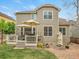 Back of the house features a deck, and a rock garden with mature landscaping at 7138 Mountain Brush Cir, Highlands Ranch, CO 80130