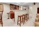 A stylish wet bar features wooden stools, granite countertops, and a wine storage at 7138 Mountain Brush Cir, Highlands Ranch, CO 80130