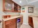 Bar area with granite countertops, wood cabinets, and a wine fridge at 7138 Mountain Brush Cir, Highlands Ranch, CO 80130