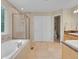 Bright bathroom featuring a soaking tub, a glass-enclosed shower, and double sinks at 7138 Mountain Brush Cir, Highlands Ranch, CO 80130