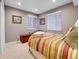 Neutral finished bedroom with a bed, side table and neutral colored walls at 7138 Mountain Brush Cir, Highlands Ranch, CO 80130