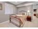 Neutral finished bedroom with a bed, side table and neutral colored walls at 7138 Mountain Brush Cir, Highlands Ranch, CO 80130