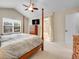 Spacious bedroom with vaulted ceiling, four-poster bed, and en-suite bathroom access at 7138 Mountain Brush Cir, Highlands Ranch, CO 80130