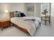 Neutral bedroom with comfortable bed, stylish side table, and soft natural lighting at 7138 Mountain Brush Cir, Highlands Ranch, CO 80130
