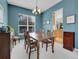 Formal dining room with blue walls, neutral carpet, wainscoting, and a chandelier lighting fixture at 7138 Mountain Brush Cir, Highlands Ranch, CO 80130