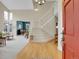 Bright entryway with hardwood floors, staircase, and view into the living and dining areas at 7138 Mountain Brush Cir, Highlands Ranch, CO 80130