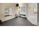 A home gym features a mirrored wall, exercise balls, black padded floor, and exercise equipment at 7138 Mountain Brush Cir, Highlands Ranch, CO 80130